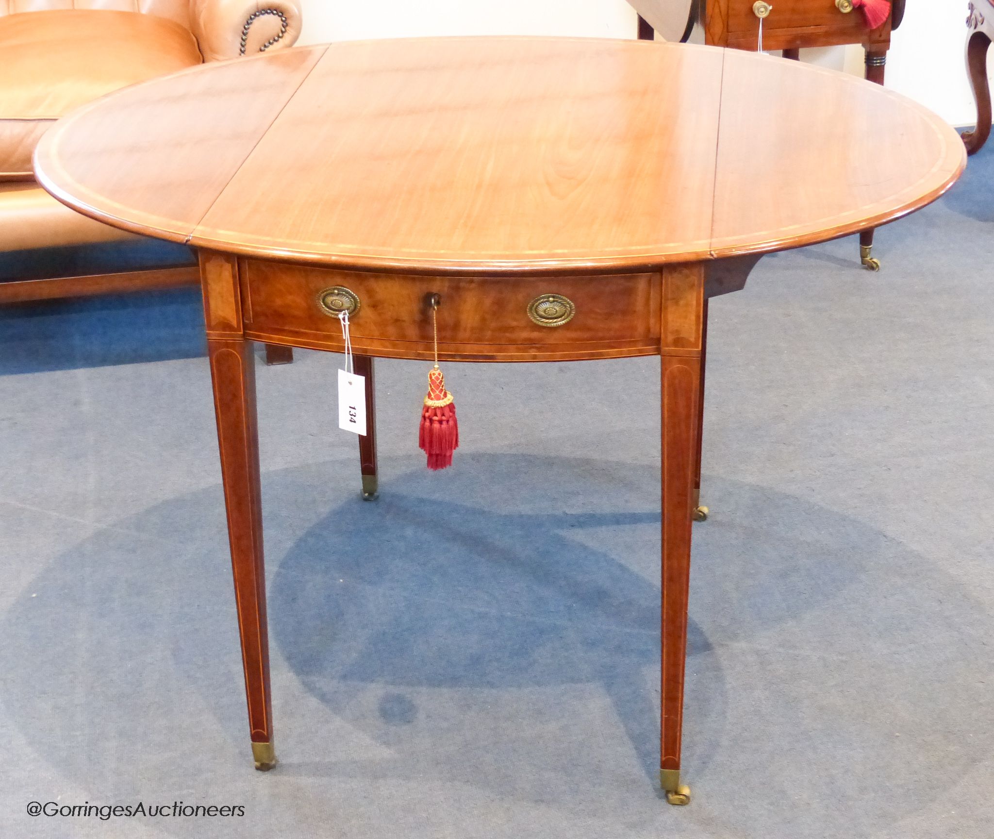 A George III Sheraton period mahogany and satinwood banded oval Pembroke table, 111.5 cm long when open, 83.5 cm deep, 72 cm high